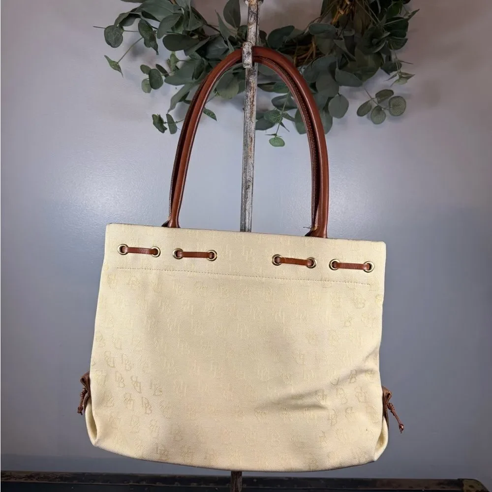 Dooney and Bourke Beige Canvas and Leather Signature Tassel Tote Handbag